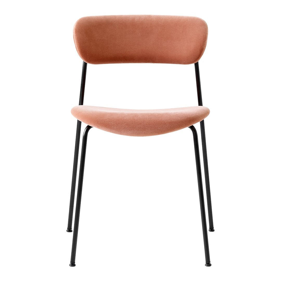 Blush pink velvet chair with a smooth, curved back and sleek black metal legs for a modern touch.