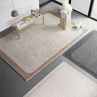 Neutral-toned area rugs featuring textured patterns in beige, gray, and blush pink. Perfect for modern interiors.