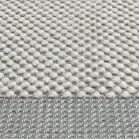 Light gray textured fabric featuring a dotted pattern with a smooth woven edge. Perfect for modern decor.