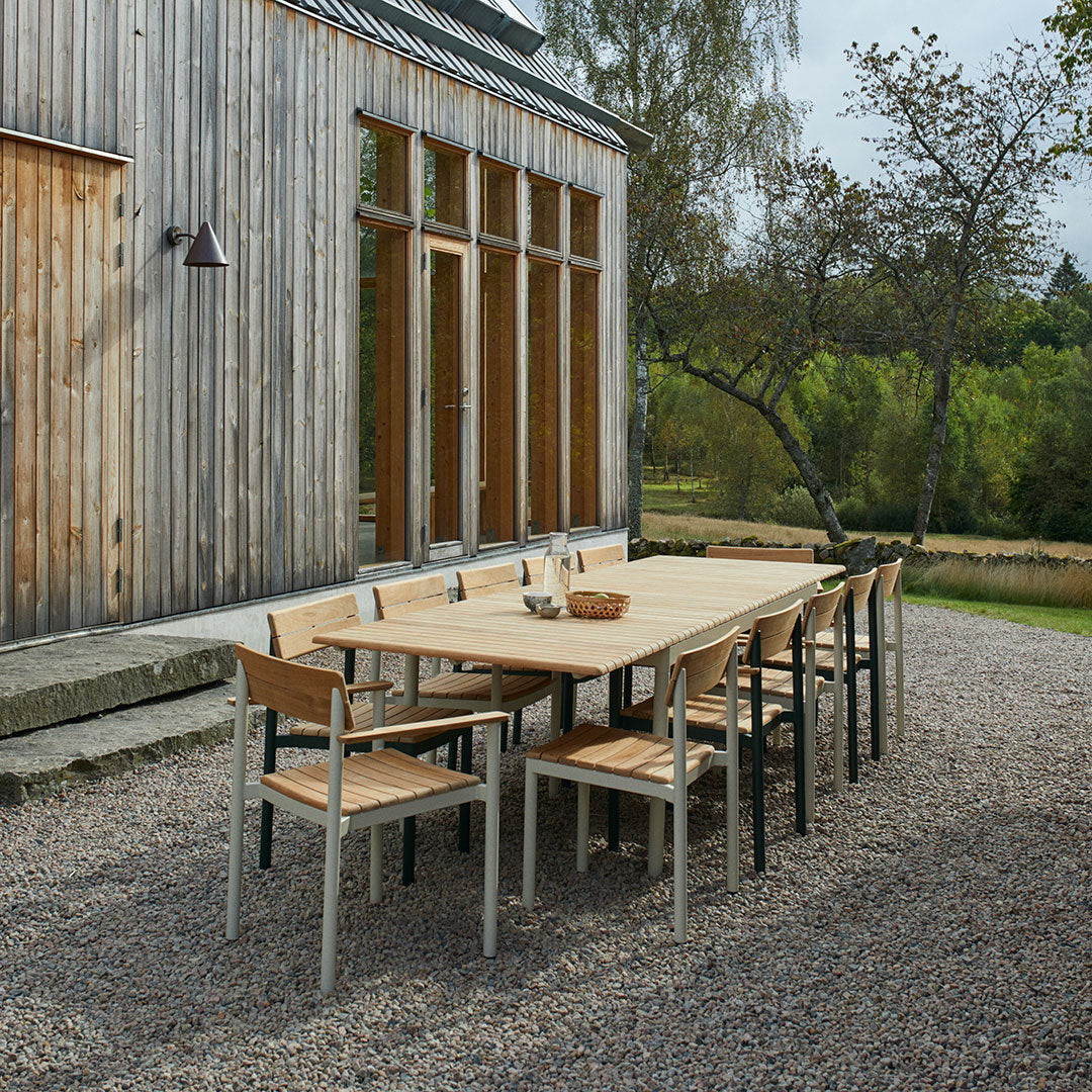"Natural wood dining table with light brown and beige tones, complemented by simple, modern chair designs."