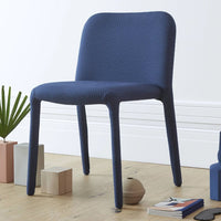 Navy blue, textured chair with smooth lines, perfect for modern interiors. Ideal for dining or office spaces.