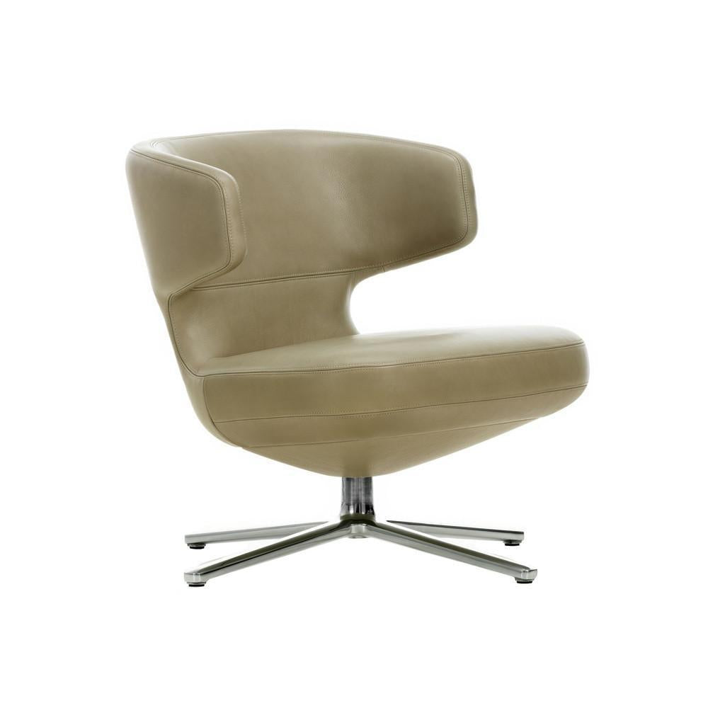 Beige modern chair with a sleek curve and smooth surface, featuring a minimalist design and chrome base.