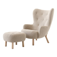 Cream-colored upholstered armchair with a matching ottoman, featuring a soft, textured fabric and natural wood legs.