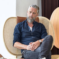 Stylish navy blue shirt with a textured pattern, paired with gray jeans for a modern, casual look.