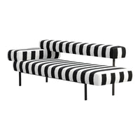Black and white striped sofa with bold zigzag pattern, modern design, and sleek black metal legs.