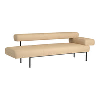 Beige leather sofa with sleek black metal legs, featuring a minimalistic and modern design.