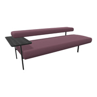 Modern burgundy sofa with sleek black side table, showcasing a minimalist design and clean lines.