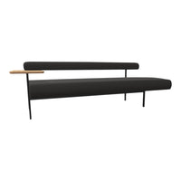 Modern black sofa with sleek lines and a contrasting wooden side table, perfect for stylish interiors.