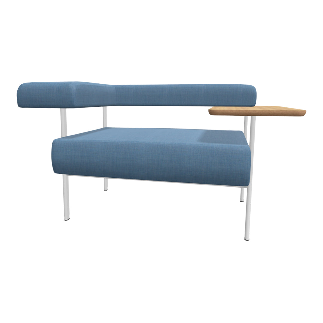 Blue fabric armchair with a smooth texture and a natural wood table, featuring white metal legs.