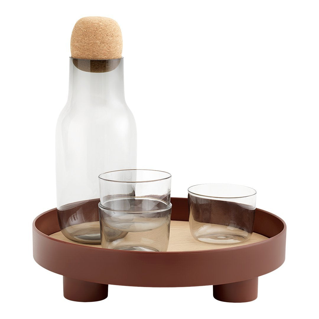 Clear glass carafe and glasses on a brown tray with a natural cork stopper, featuring a minimalist and modern design.