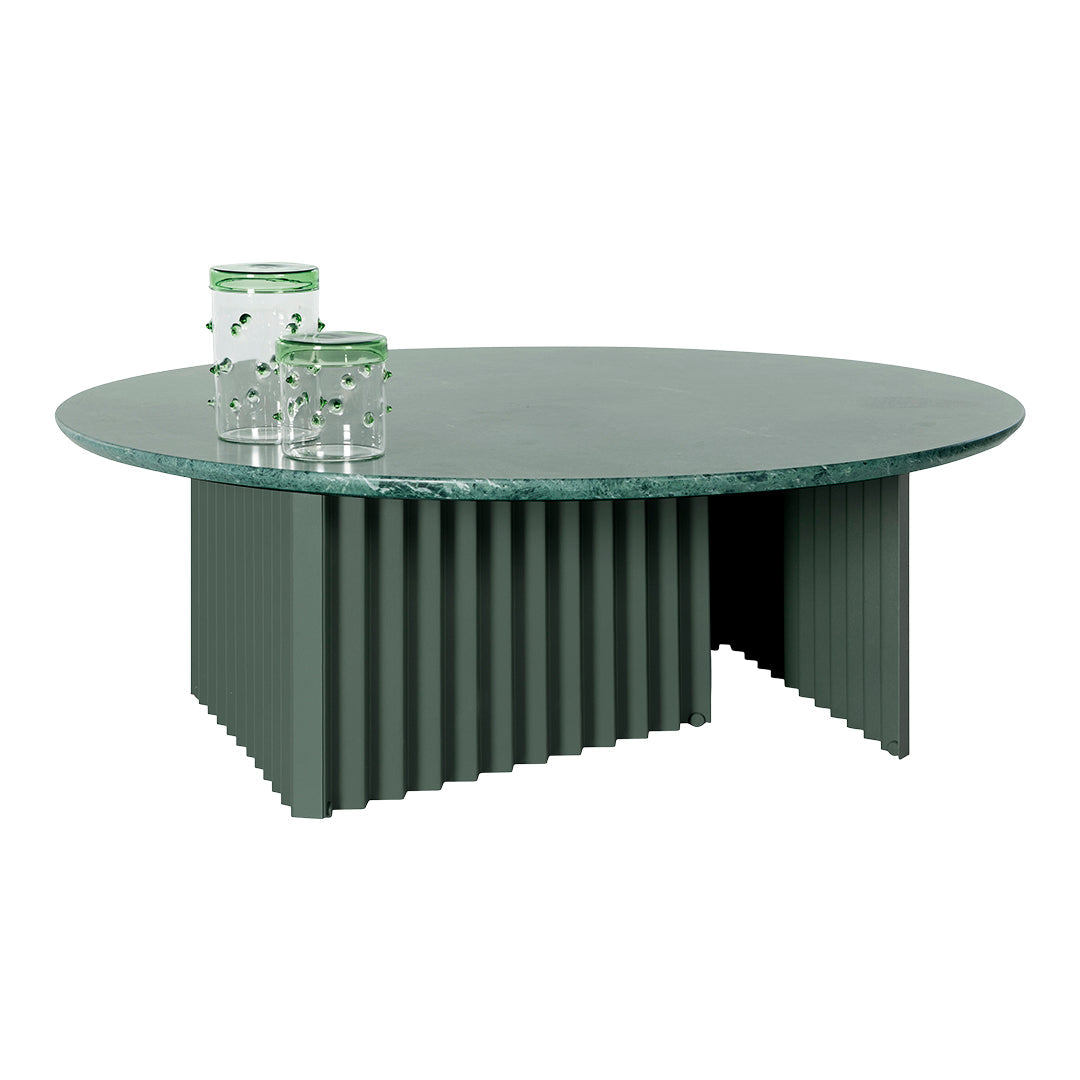 Green round coffee table with ribbed base and marble top, complemented by clear, dotted green glass vases.