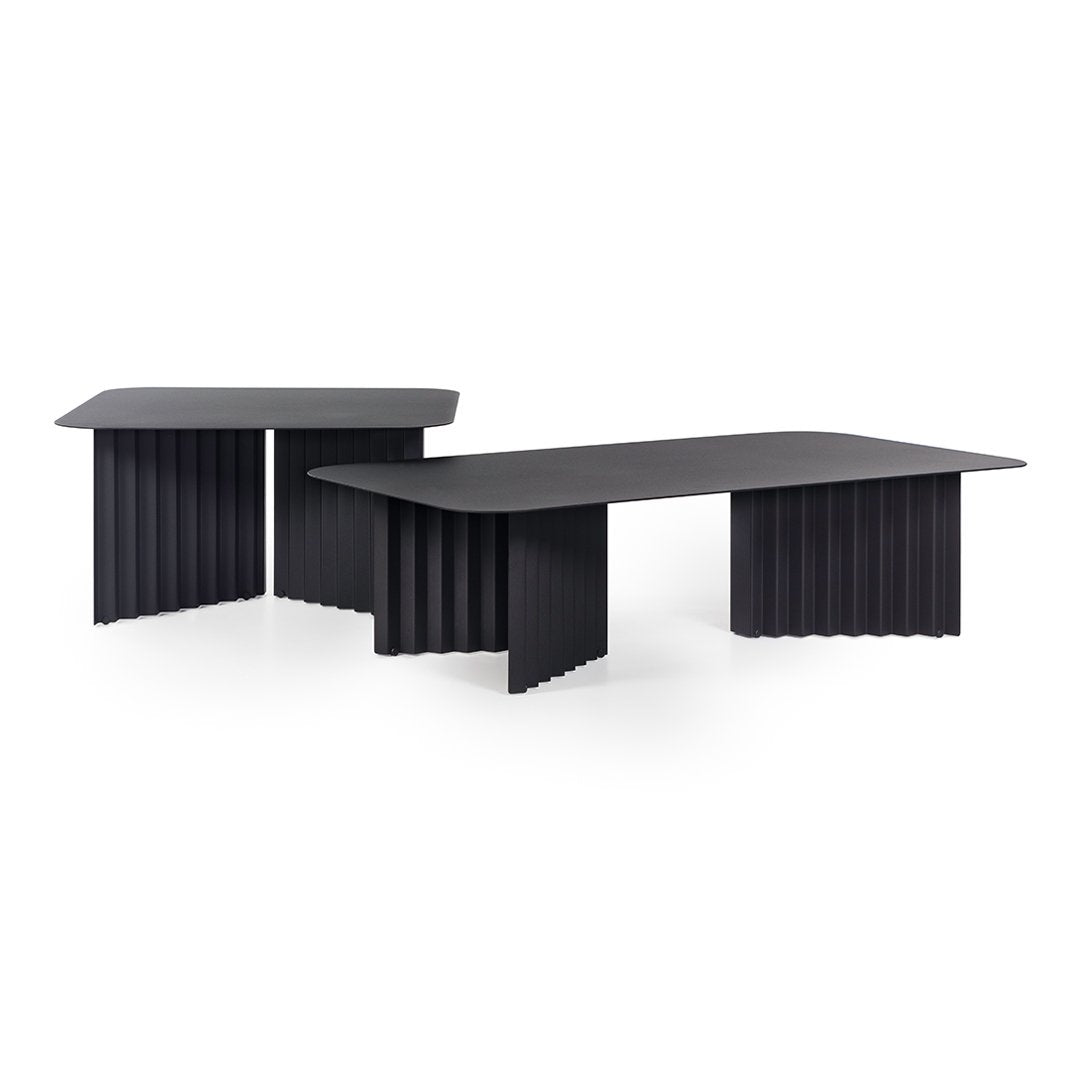 Black coffee tables featuring textured, ribbed designs and sleek, modern shapes against a white background.