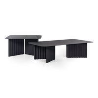 Black coffee tables featuring textured, ribbed designs and sleek, modern shapes against a white background.