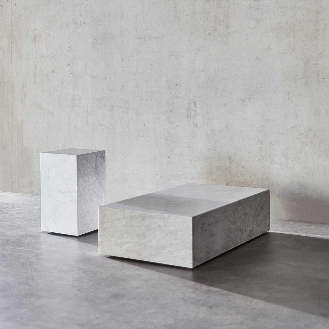 Minimalist concrete coffee tables in smooth gray finish, showcasing clean lines and geometric shapes.