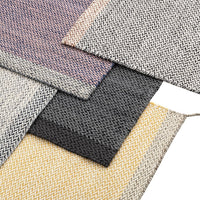 Herringbone-patterned fabrics in shades of purple, grey, black, yellow, and off-white create a chic, modern look.