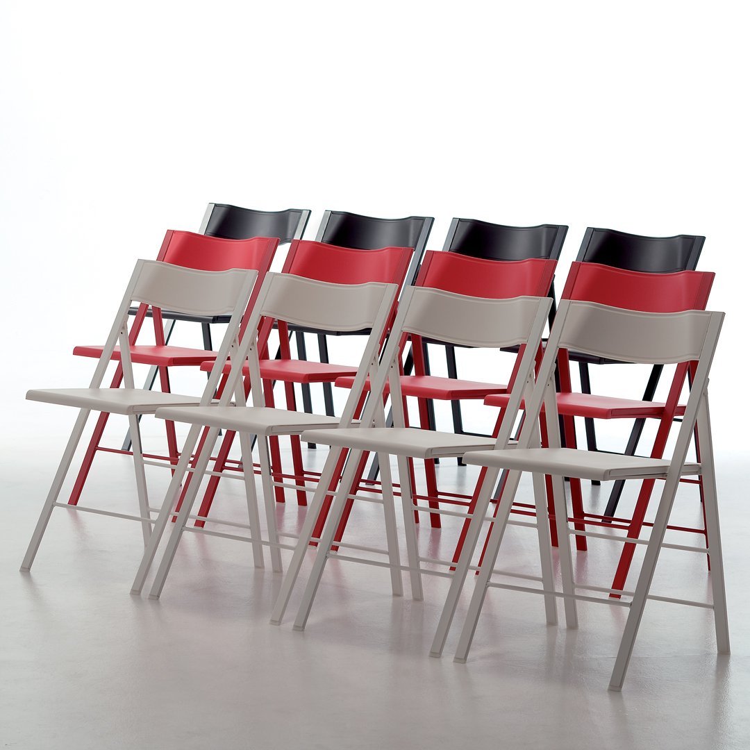 Colorful folding chairs in red, black, and grey with sleek, modern patterns, arranged in a row.