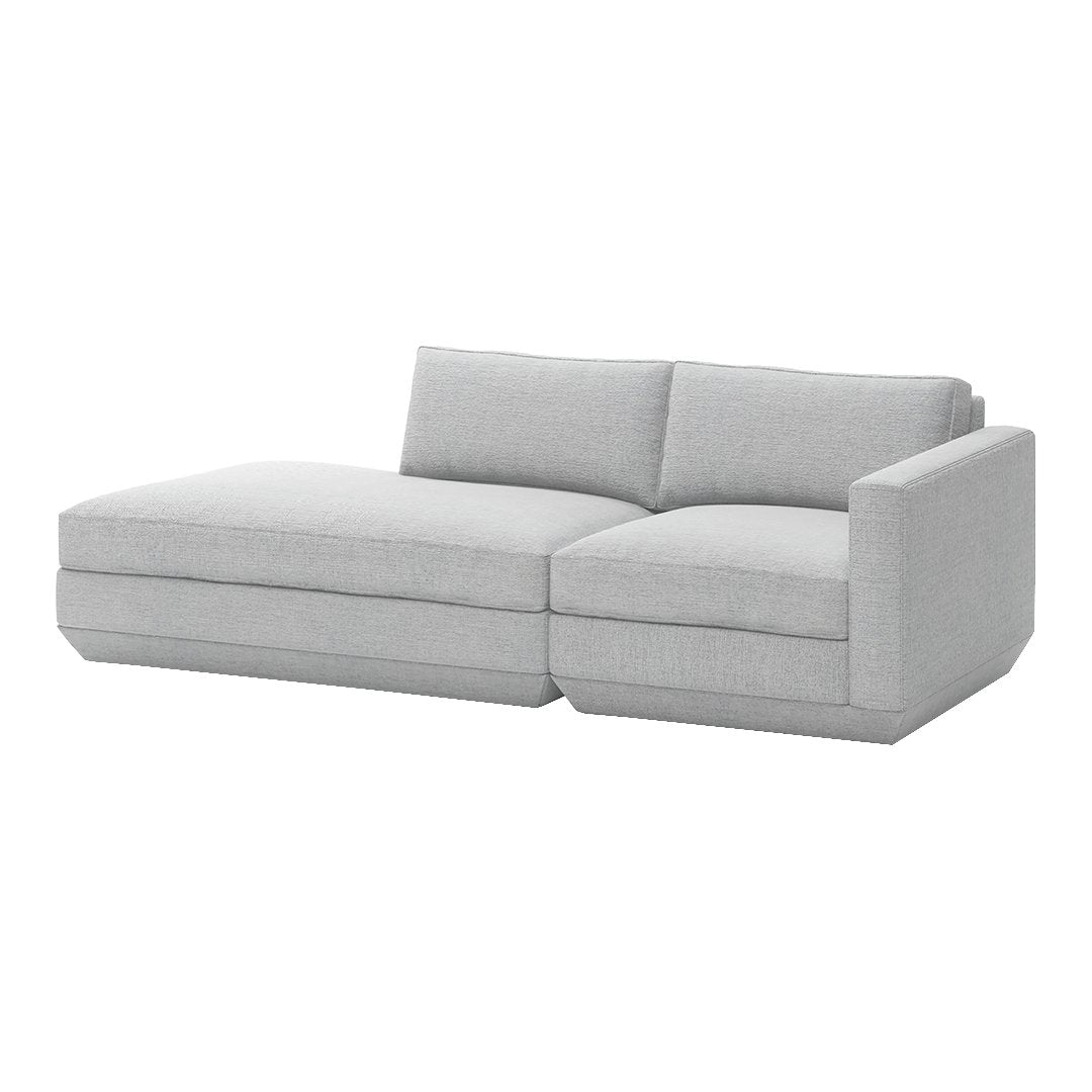 Light gray sectional sofa with a modern minimalist design and smooth fabric texture, perfect for contemporary spaces.
