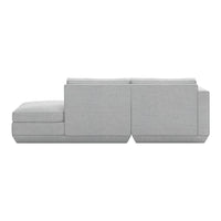 Light gray sectional sofa with a smooth, minimalist design and subtle texture. Ideal for modern interiors.