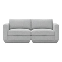 Light gray upholstered couch with a smooth texture and minimalist design, featuring two wide seat cushions.