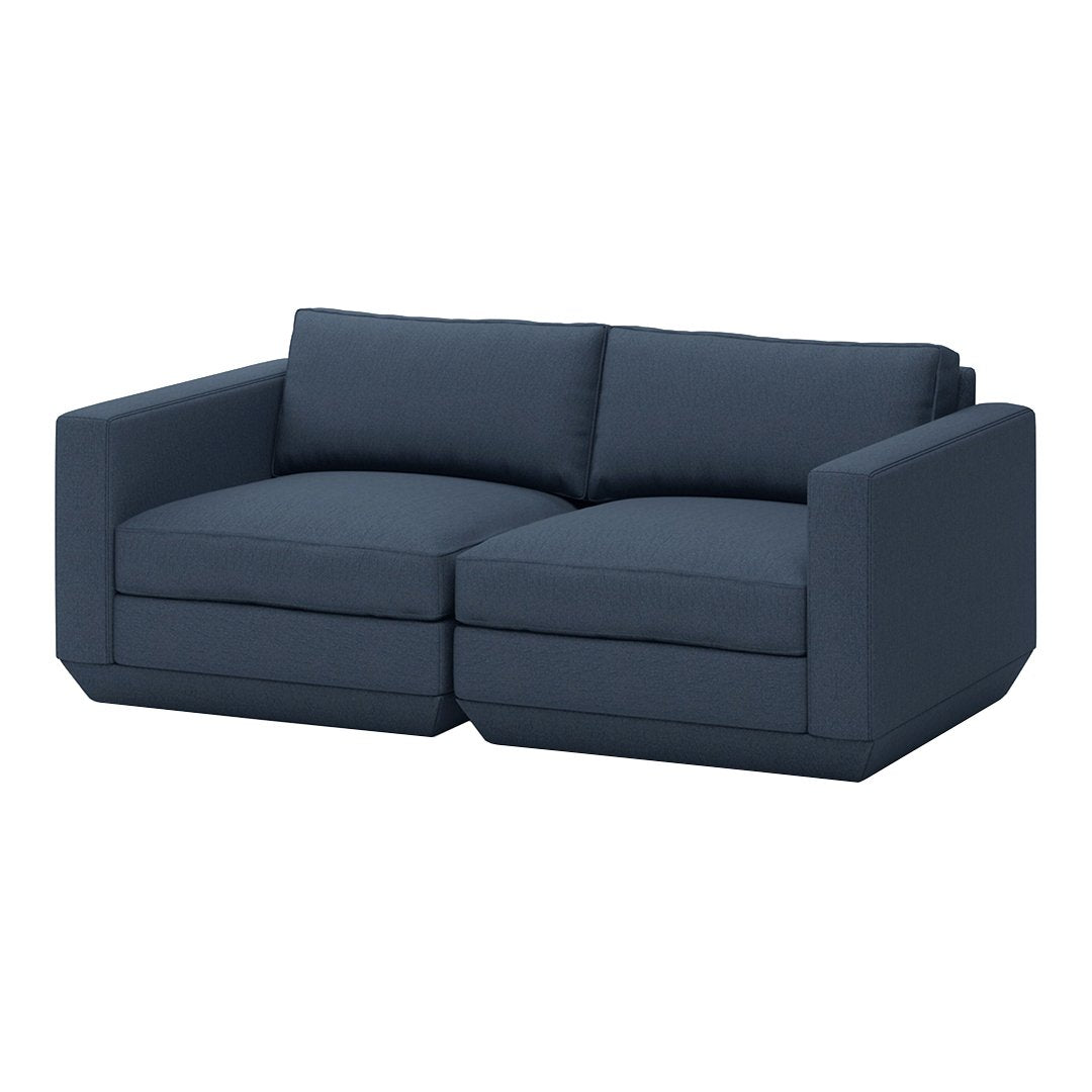 Dark navy blue sectional sofa with a smooth, solid fabric and contemporary design for modern living spaces.