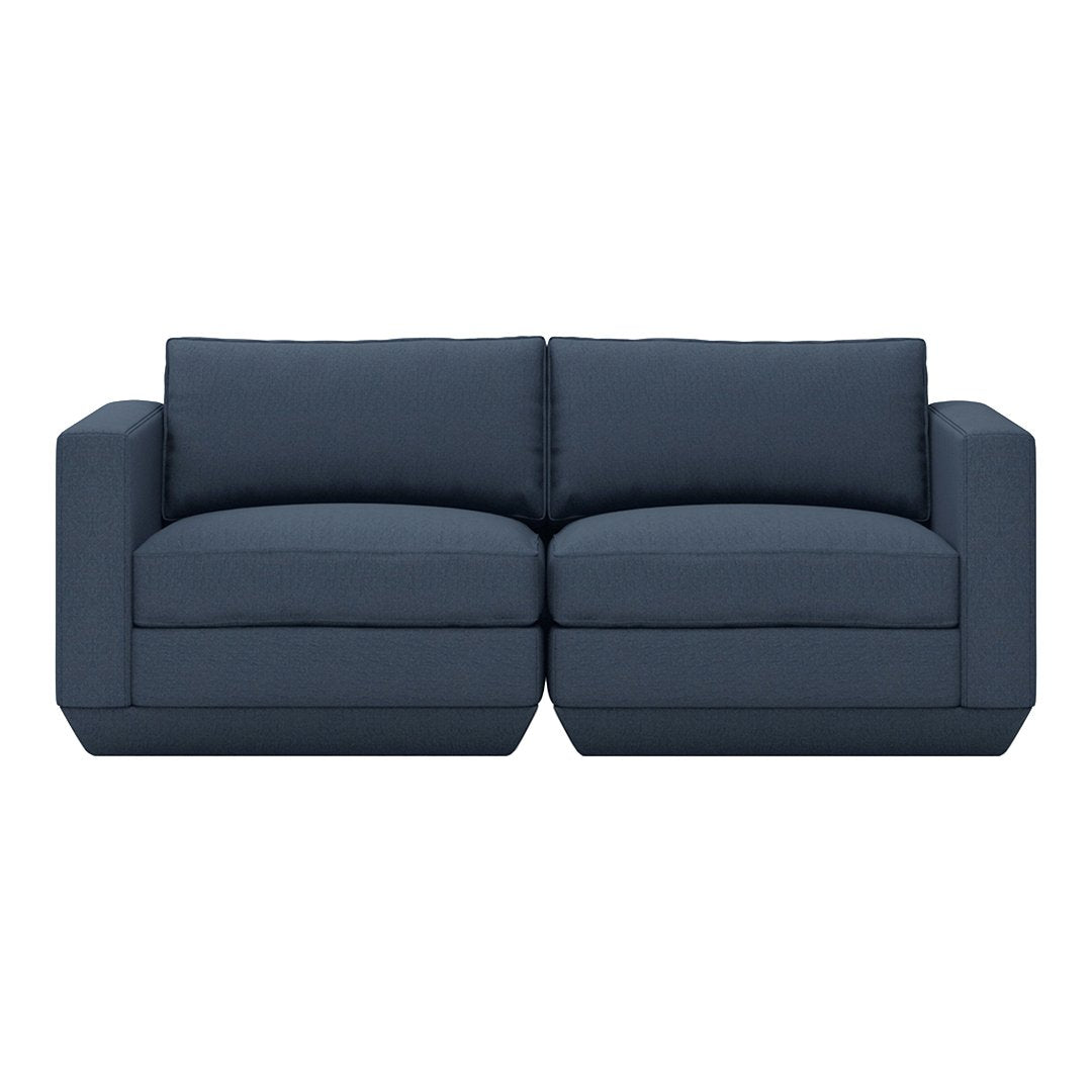 Navy blue fabric sofa with simple, modern design and plush cushions, perfect for contemporary living spaces.