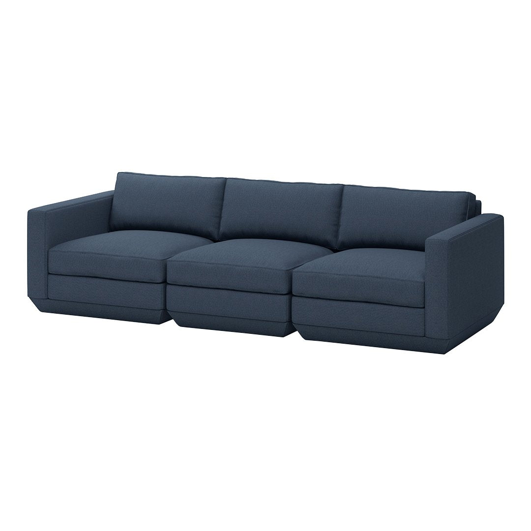 Dark navy blue sectional sofa with clean lines and a modern, minimalist design. Soft, solid color upholstery.