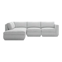 L-shaped sectional sofa in soft light gray fabric with seamless, minimalist design and plush cushions.