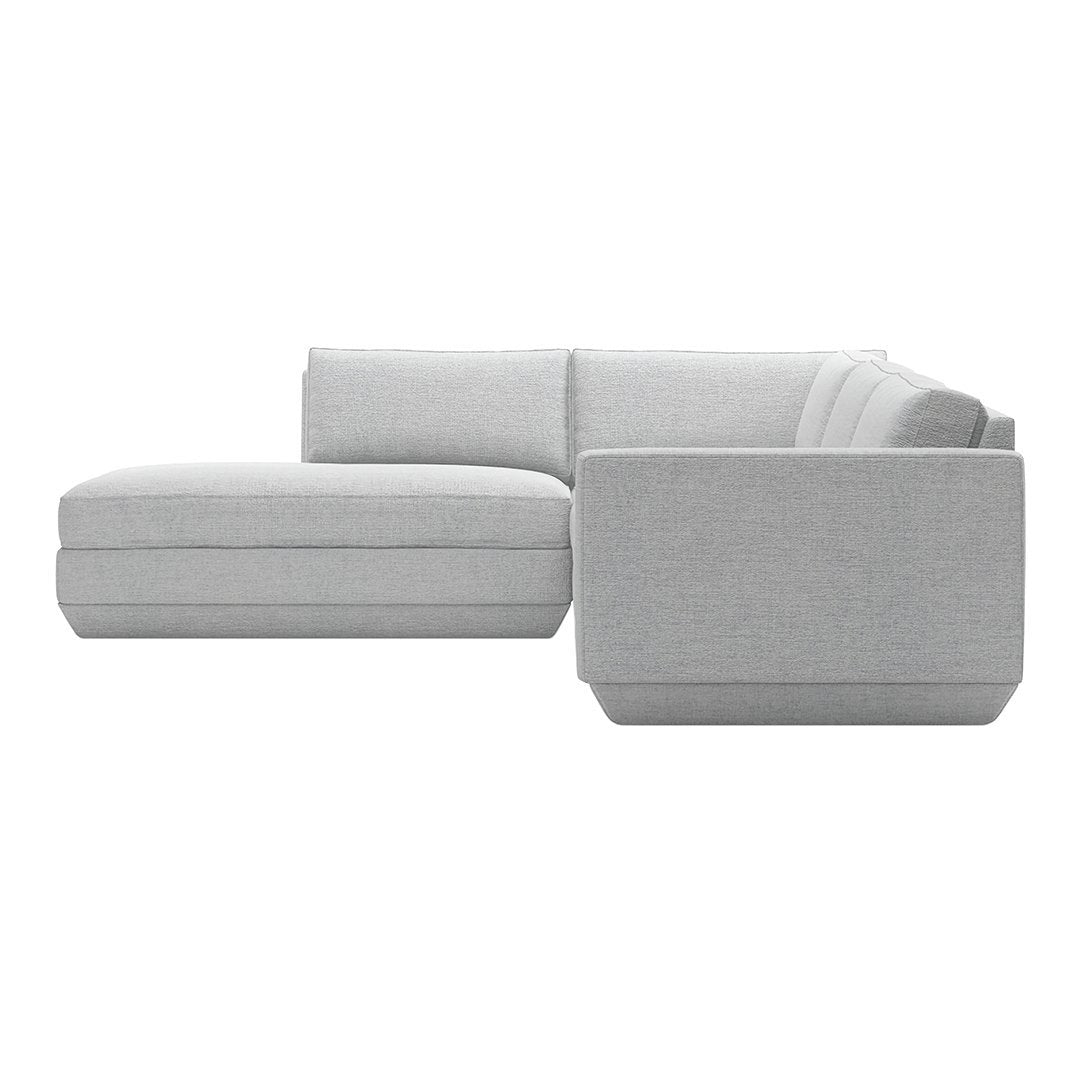 Light gray sectional sofa with smooth, minimalist upholstery and clean lines, perfect for modern living spaces.