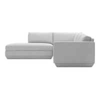 Light gray sectional sofa with smooth, minimalist upholstery and clean lines, perfect for modern living spaces.
