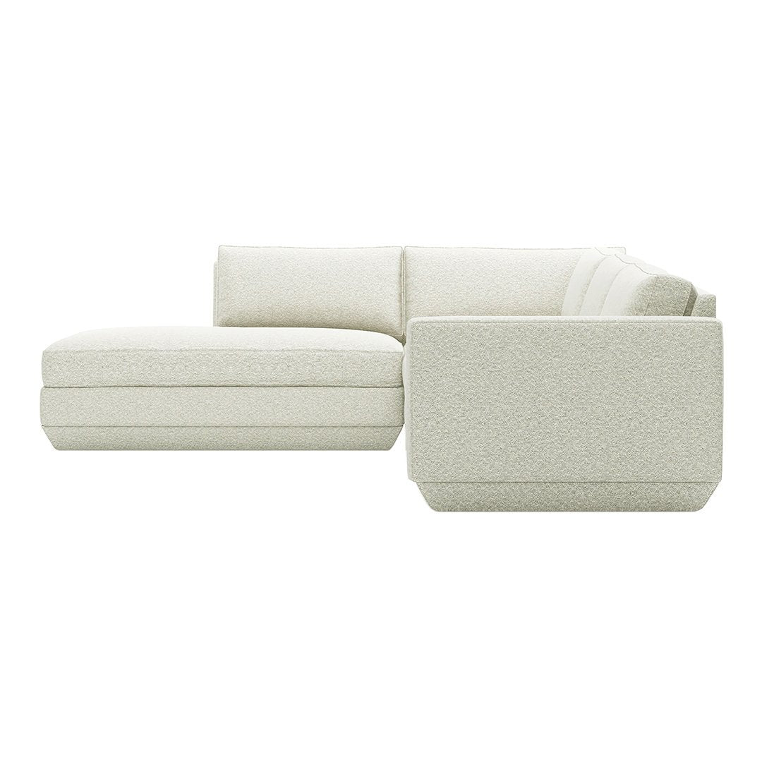 Light cream modular couch with a textured, soft fabric and modern, minimalist design. Perfect for contemporary decor.