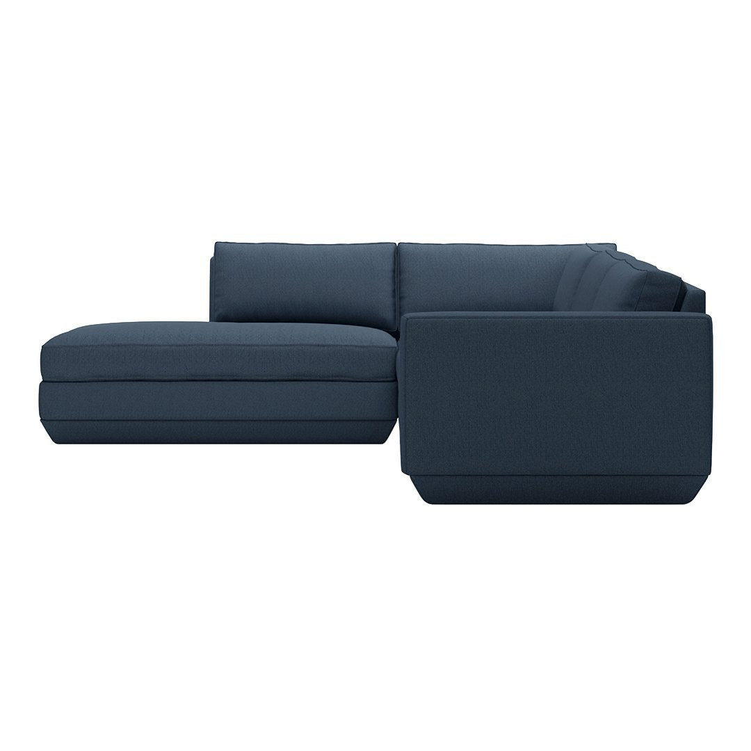 Dark blue sectional sofa with a clean, modern design and sleek, smooth upholstery.