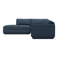 Dark blue sectional sofa with a clean, modern design and sleek, smooth upholstery.