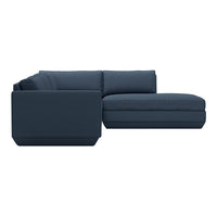 Navy blue sectional sofa with clean lines and a modern design, featuring solid color upholstery and plush cushions.