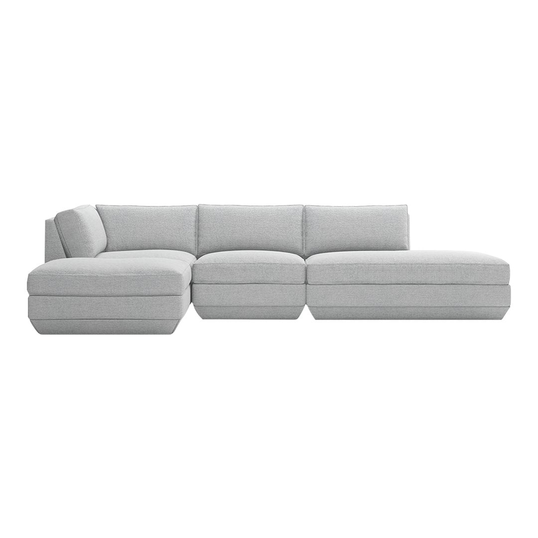 Light grey sectional sofa with a smooth, minimalist design, featuring soft fabric and no noticeable patterns.