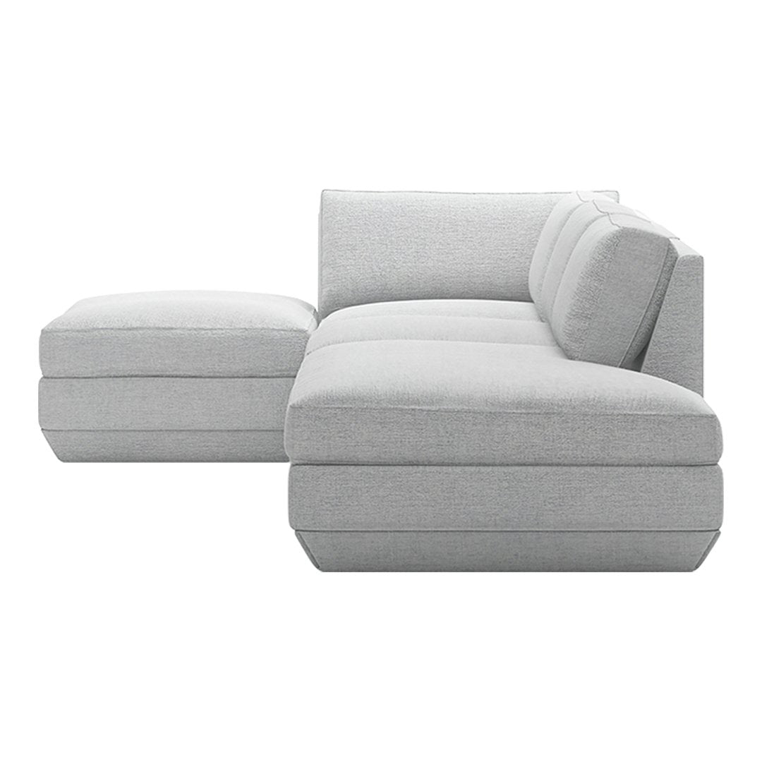 Gray sectional sofa with a minimalist design and plush cushions, featuring a sleek, uniform fabric pattern.