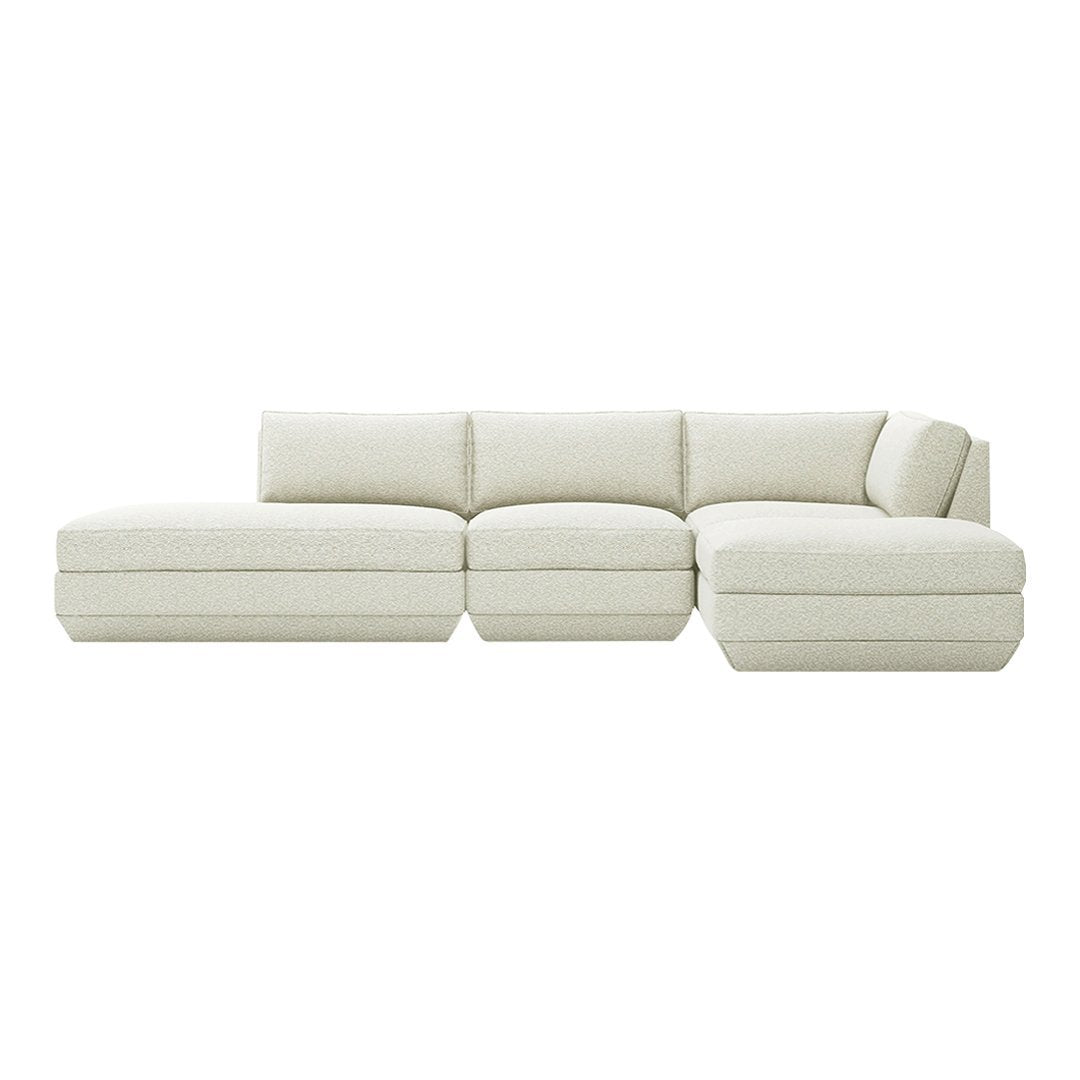Modern sectional sofa in a soft cream color with a textured fabric, featuring minimalistic design and smooth lines.