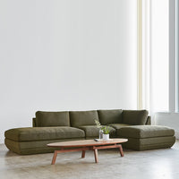 Olive green sectional sofa with smooth fabric and contemporary design, paired with a simple wooden coffee table.