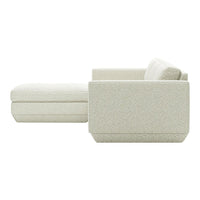 Light beige sectional sofa with a textured pattern, showcasing modern minimalist design and soft, neutral tones.