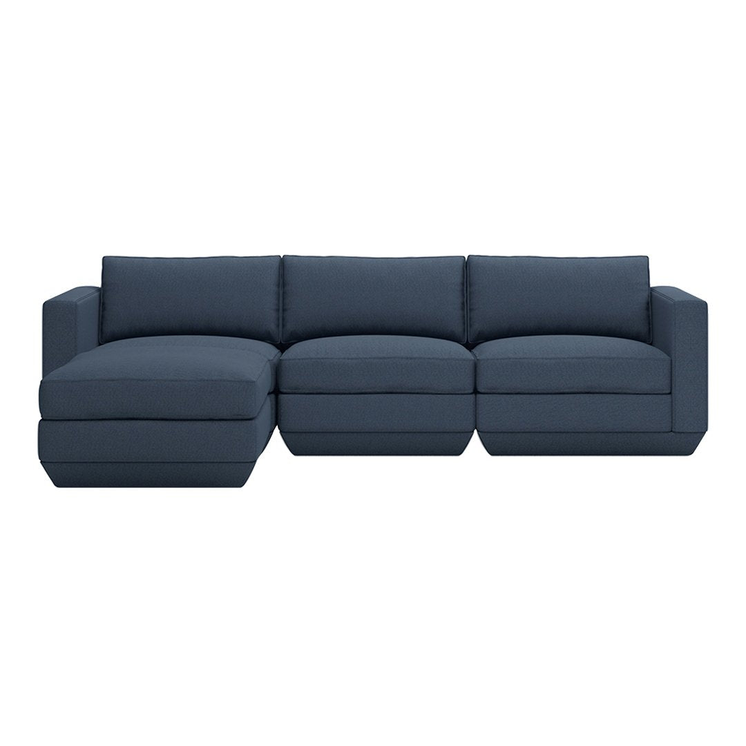 Navy blue sectional sofa with a smooth fabric pattern and modern design, featuring plush cushions for comfort.