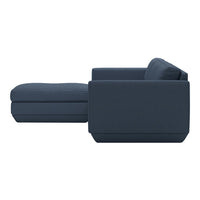 Navy blue sectional sofa with clean lines and a modern design, featuring a solid color and minimalist style.