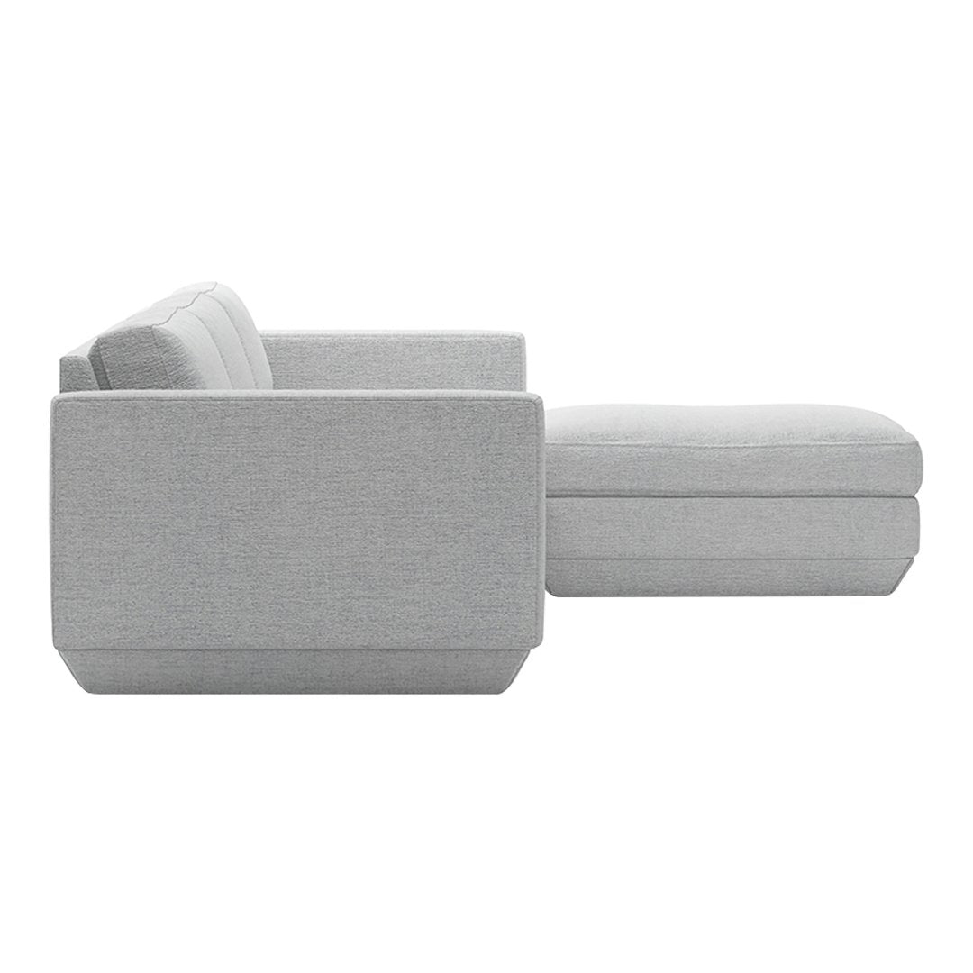 Light gray sectional sofa with a smooth, textured fabric and clean lines, perfect for modern living spaces.