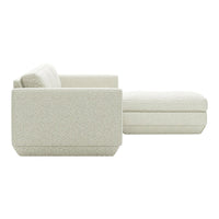 Light beige, textured upholstery with subtle patterns on a contemporary sectional sofa with a spacious chaise lounge.