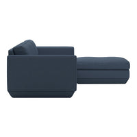 Modern navy blue sectional sofa with a sleek, minimalist design and soft, textured fabric. Perfect for contemporary decor.