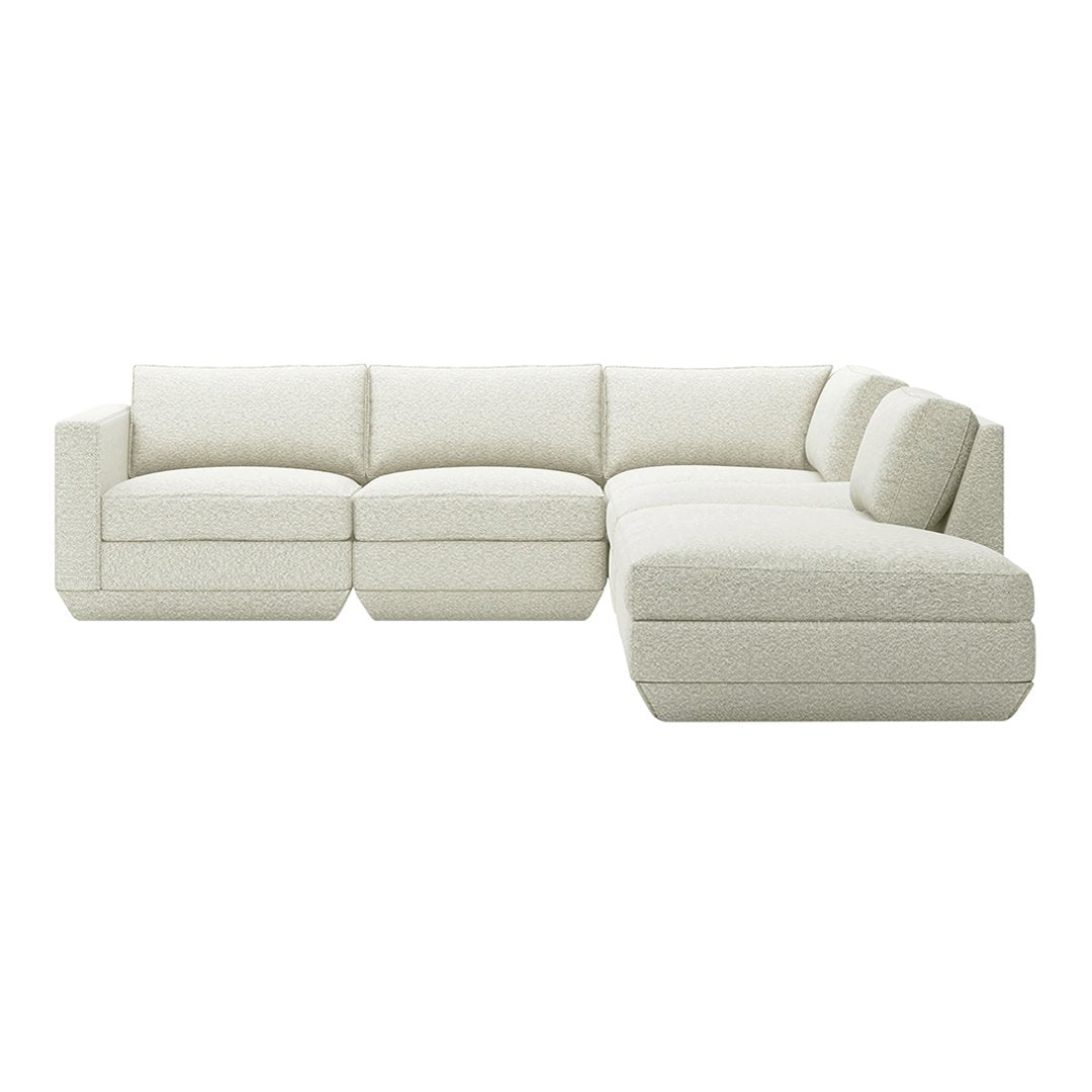 Light beige sectional sofa with soft, textured fabric and minimalist design, perfect for modern decor.