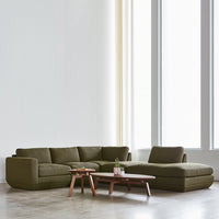 Olive green sectional sofa with smooth fabric and minimalist design, paired with a simple wooden coffee table.