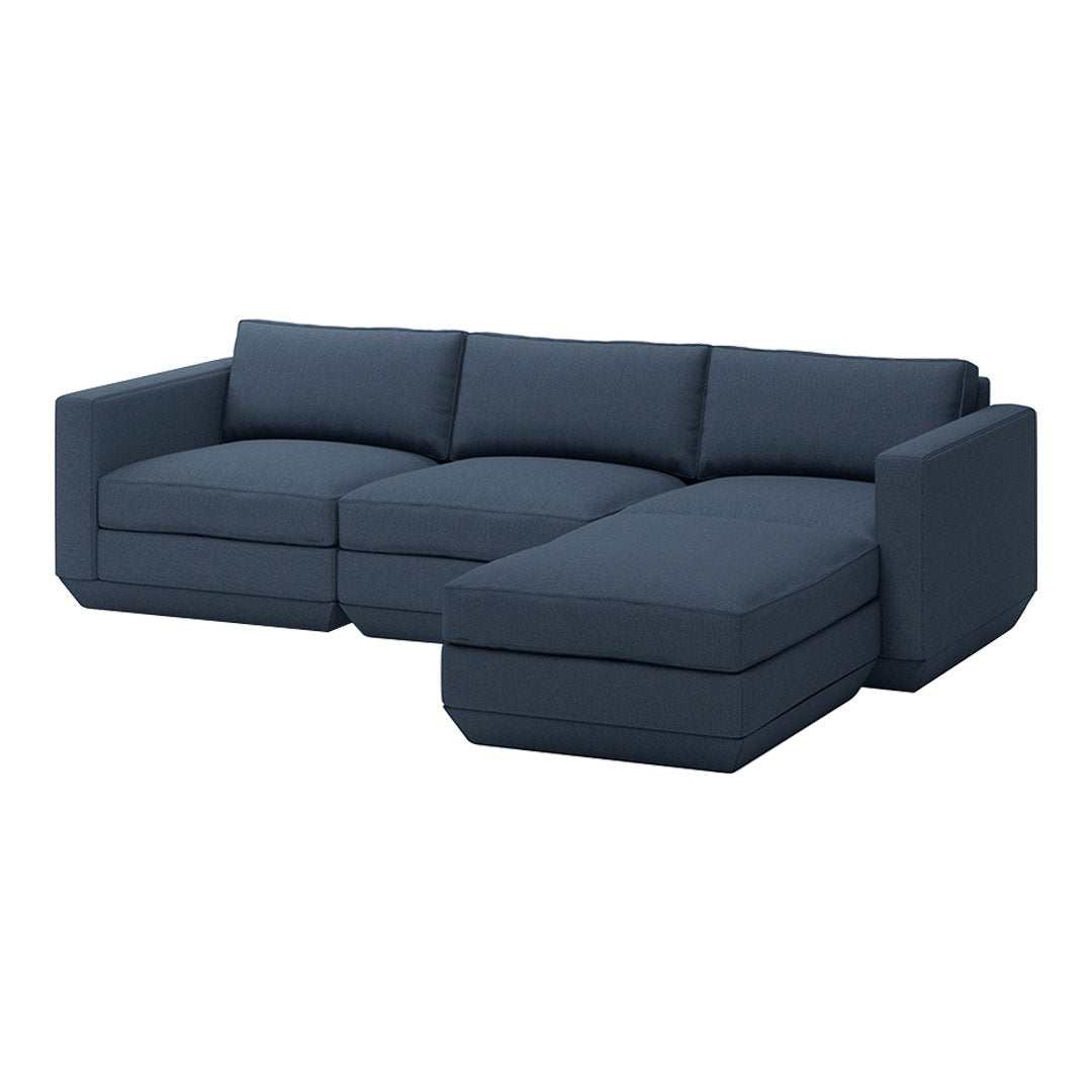 Navy blue sectional sofa with clean lines and a modern design, featuring a solid color and plush upholstery.