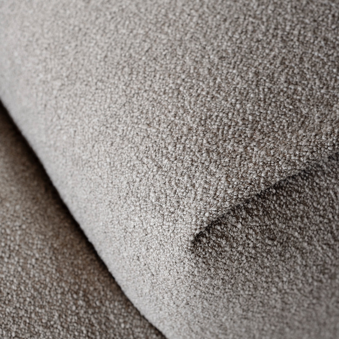Textured beige fabric with a soft, plush surface, featuring subtle variations in color and depth. Perfect for upholstery.