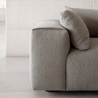 Soft gray textured fabric sofa with a clean, modern design and matching throw pillow, ideal for contemporary decor.