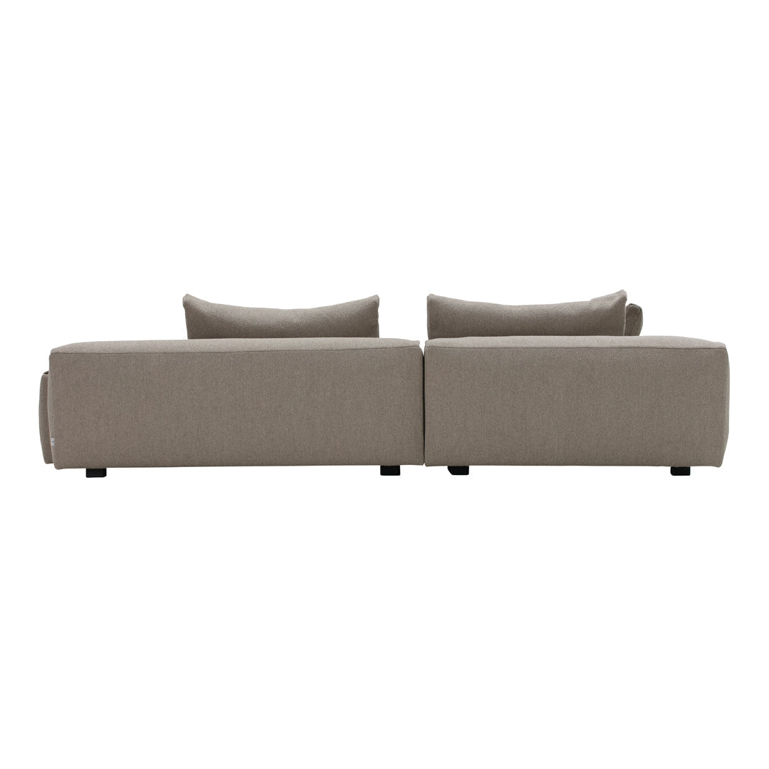 Modern beige sofa with a textured fabric and minimalist design, featuring soft cushions and clean lines.