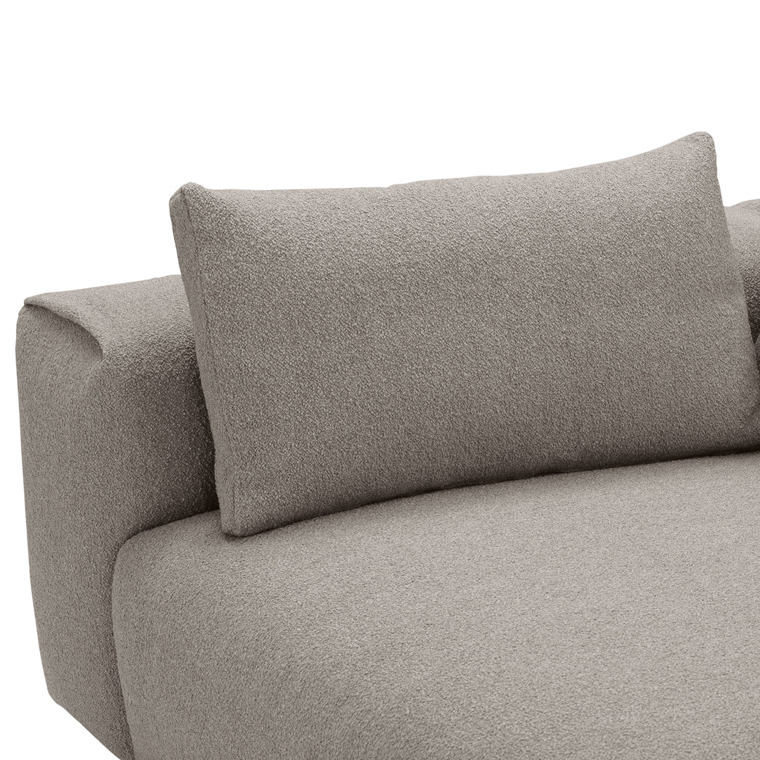 Soft beige sofa with textured fabric and matching pillow, ideal for modern home decor. 